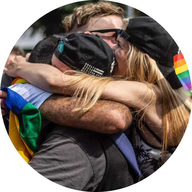 People hugging at pride parade